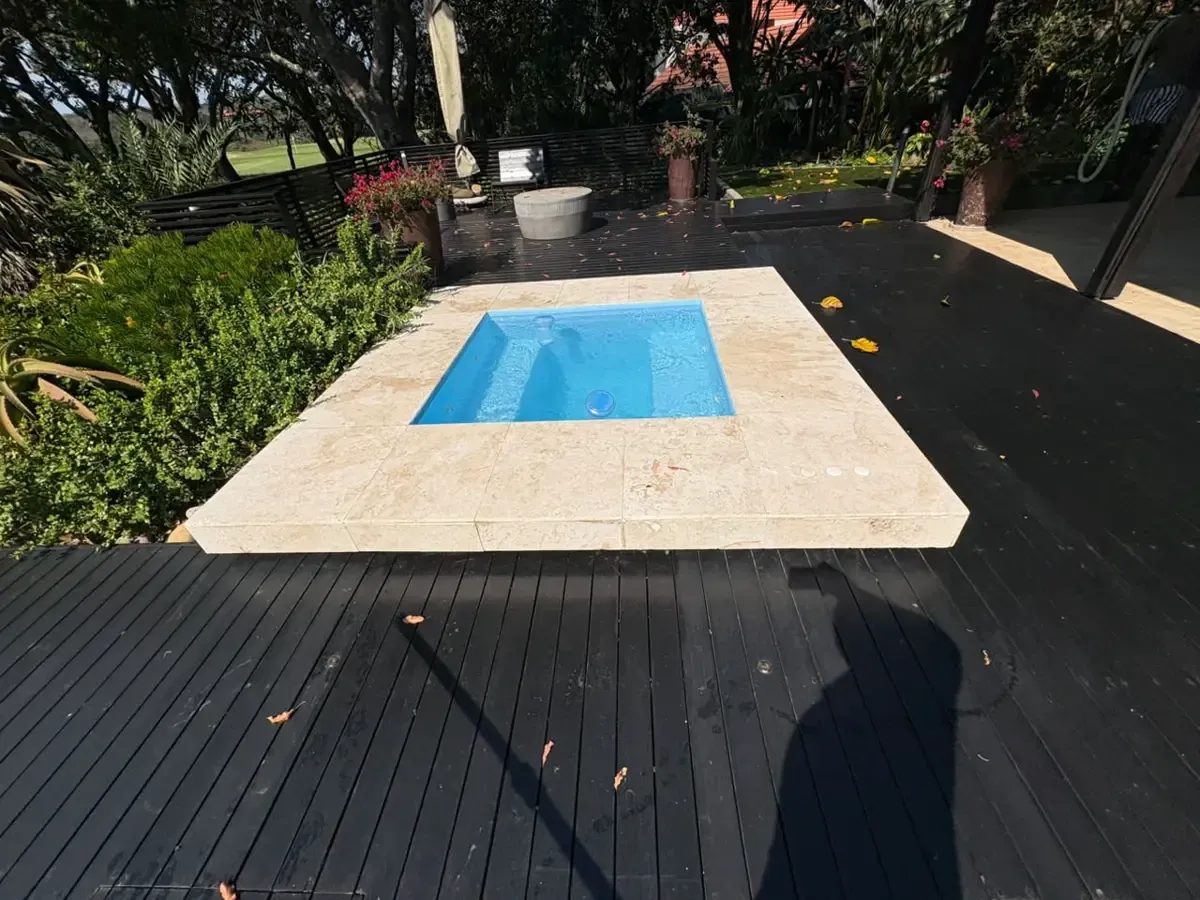 Clean blue swimming pool built and maintained by Walters Pool and Construction